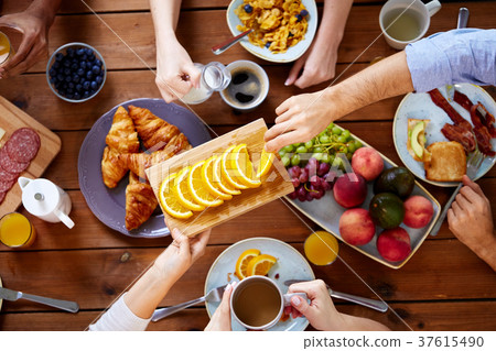 group of people having breakfast at table group of people having breakfast at table 37615490