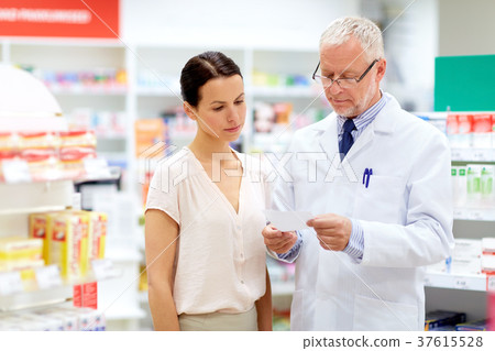apothecary and woman with prescription at pharmacy 37615528