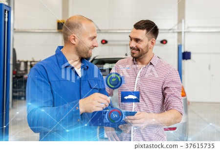 auto mechanic with clipboard and man at car shop 37615735