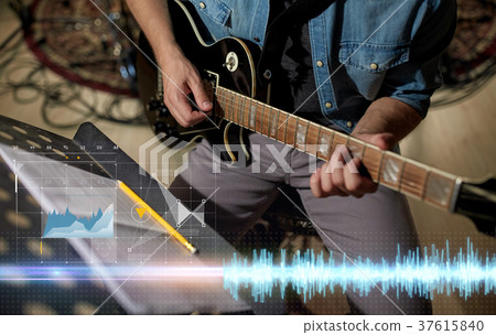 man with music book on stand playing guitar 37615840