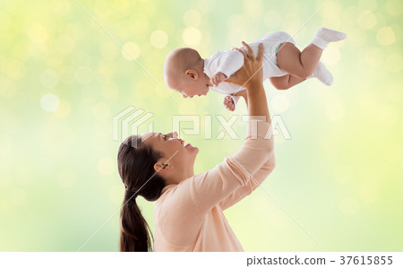 happy mother playing with little baby over green happy mother playing with little baby over green 37615855