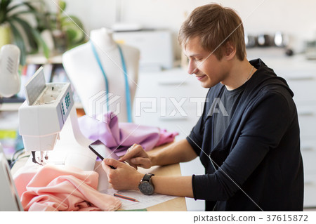 fashion designer with tablet pc working at studio fashion designer with tablet pc working at studio 37615872