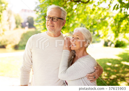 happy senior couple hugging at summer park happy senior couple hugging at summer park 37615903