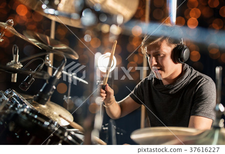 male musician playing drum kit at concert 37616227