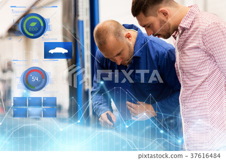 auto mechanic with clipboard and man at car shop 37616484