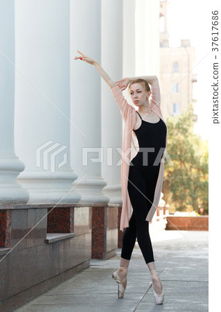 Ballerina in pointe dancing in street. Ballerina in pointe dancing in street. 37617686