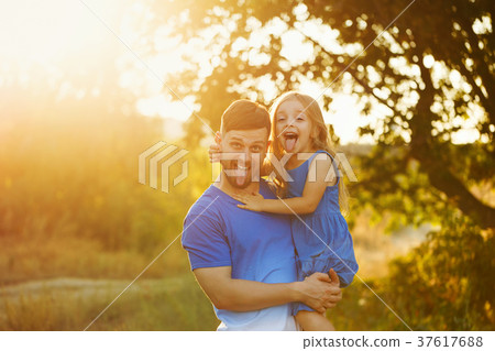 Father holds daughter on hands Father holds daughter on hands 37617688