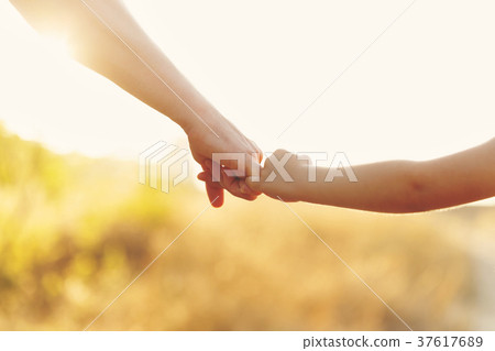 Father holds his daughter's hand Father holds his daughter's hand 37617689
