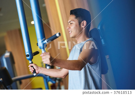 Men exercising in the gym 37618513