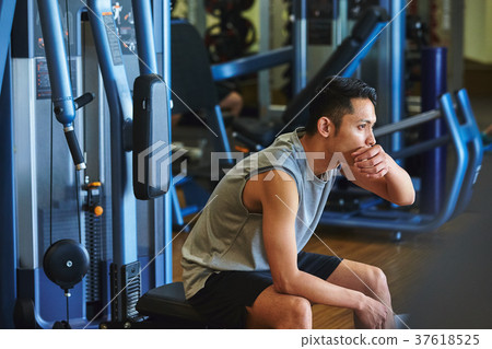 Men exercising in the gym 37618525