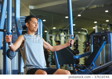 Men exercising in the gym 37618548