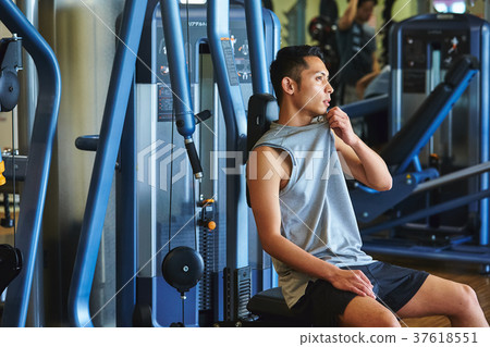 Men exercising in the gym 37618551