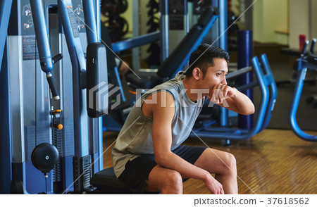 Men exercising in the gym 37618562