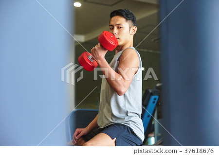 Men exercising in the gym 37618676