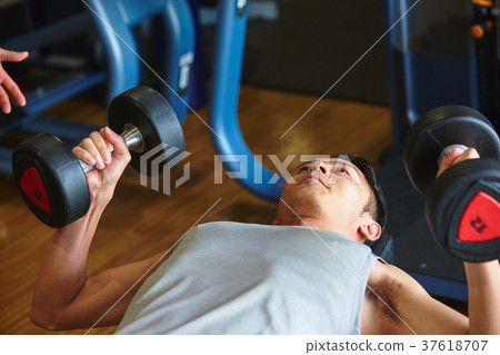Men exercising in the gym 37618707