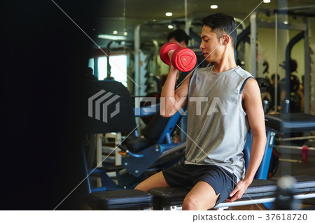 Men exercising in the gym 37618720