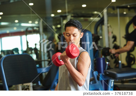 Men exercising in the gym 37618738