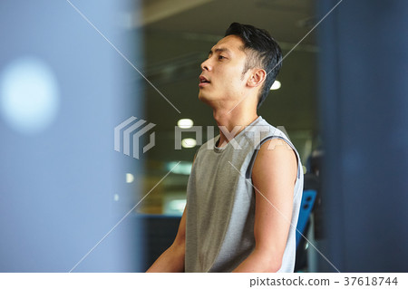 Men exercising in the gym 37618744