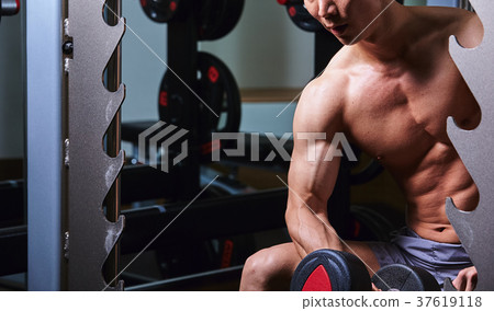 Men exercising in the gym 37619118