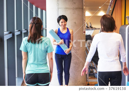 Woman and trainer exercising in the gym Woman and trainer exercising in the gym 37619138