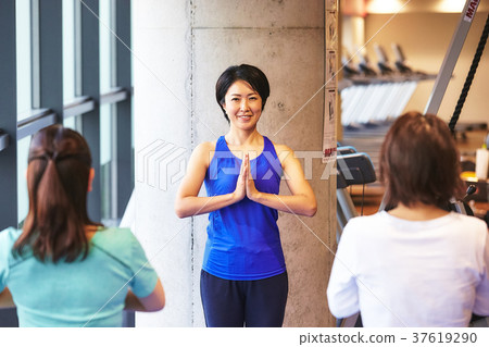 Woman and trainer exercising in the gym Woman and trainer exercising in the gym 37619290