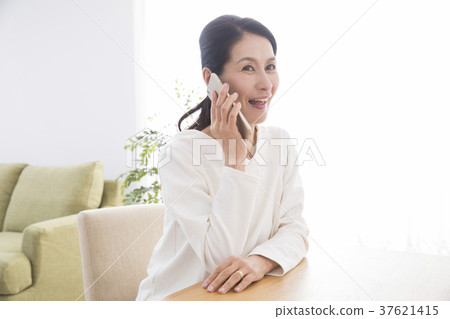 Woman speaking on the phone Woman speaking on the phone 37621415