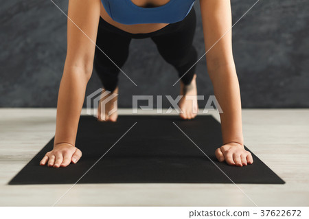 Unrecognizable woman training yoga in plank pose Unrecognizable woman training yoga in plank pose 37622672