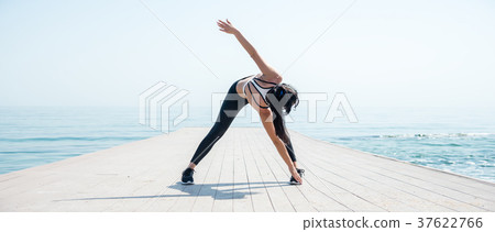 Fitness Girl working out on the beach 37622766