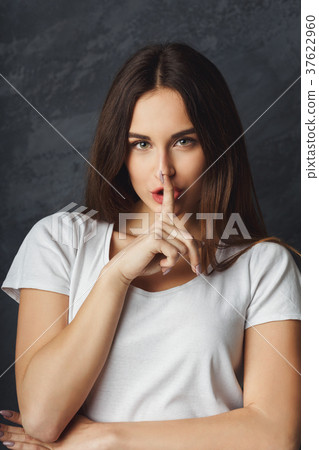 Woman saying be quiet with finger on lips gesture Woman saying be quiet with finger on lips gesture 37622960