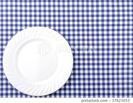 White Plate on Blue and White  Tablecloth Backgr 37623055
