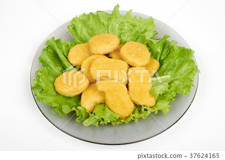 chicken nuggets and vegetables on a white plate 37624165