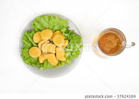 chicken nuggets , vegetables on a white plate, and chicken nuggets , vegetables on a white plate, and 37624169