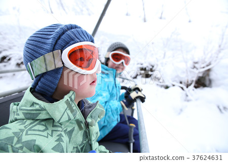 Child riding a ski lift 37624631