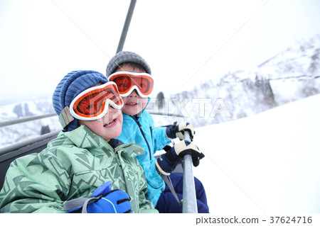 Child riding a ski lift Child riding a ski lift 37624716