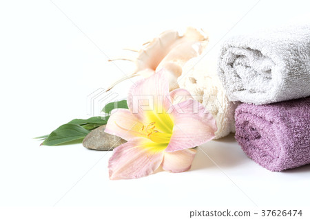 Spa setting of towel, flower on white with space. 37626474