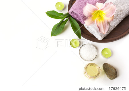 Spa setting of towel, flower on white background. 37626475