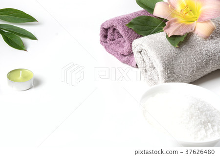 Spa setting of towel, flower on white background. 37626480