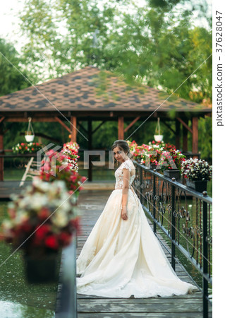 Young girl in wedding dress in park posing for Young girl in wedding dress in park posing for 37628047