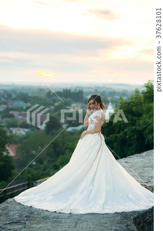 Young girl in wedding dress on city background at Young girl in wedding dress on city background at 37628101