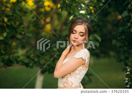 Young girl in wedding dress in park posing for Young girl in wedding dress in park posing for 37628105