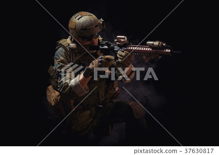 special forces soldier with a rifle is aiming at the target 37630817