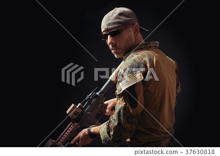 special forces soldier with a rifle looks around 37630818