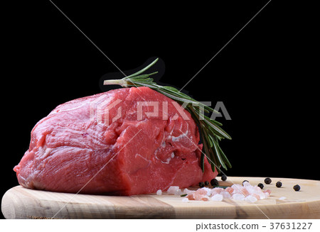 Fresh meat on a cutting board with rosemary 37631227