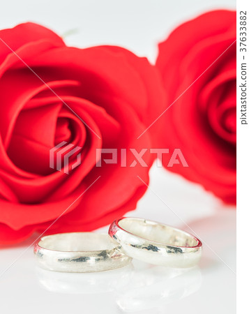 Red rose and wedding ring on white Red rose and wedding ring on white 37633882