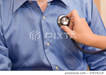 Female Doctor examining male patient. 37634219