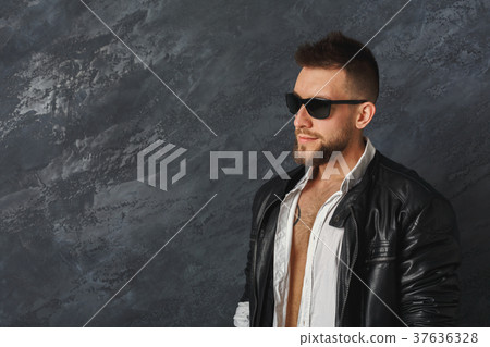 Handsome smiling man posing in studio 37636328