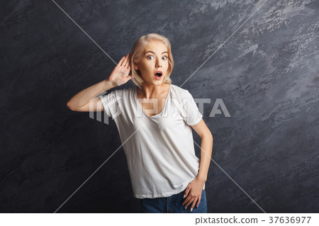 Young woman trying to listen gossip Young woman trying to listen gossip 37636977