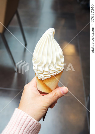 Woman holding soft cream. Vanilla ice cream. Woman holding soft cream. Vanilla ice cream. 37637340