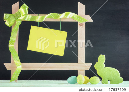Easter eggs and bunny with a frame and paper note Easter eggs and bunny with a frame and paper note 37637509