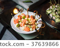 Canapes of salmon, lined on a white plate. 37639866